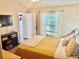 Comfortable bedroom with a view to the backyard, and easy access to the backyard at 8604 Corinthian Way, New Port Richey, FL 34654