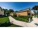 View of the side of the house with lush green landscaping and manicured bushes at 8604 Corinthian Way, New Port Richey, FL 34654