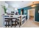 Bright kitchen with white cabinets, stainless appliances, and a breakfast bar at 8604 Corinthian Way, New Port Richey, FL 34654