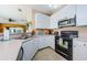 Kitchen with white cabinets and black appliances at 8604 Corinthian Way, New Port Richey, FL 34654