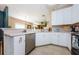 Kitchen features white cabinetry and stainless-steel appliances at 8604 Corinthian Way, New Port Richey, FL 34654