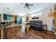 Bright living room with hardwood floors, a comfortable couch, and stylish decor throughout at 8604 Corinthian Way, New Port Richey, FL 34654