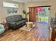 Cozy living area with a comfortable sofa, sliding glass doors and view of the backyard at 8604 Corinthian Way, New Port Richey, FL 34654