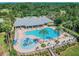 Aerial view of the community pool with splash pad and seating areas at 8635 Creedmoor Ln, New Port Richey, FL 34654