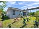 Spacious backyard featuring a swing set, well-maintained lawn, and a charming patio area at 8635 Creedmoor Ln, New Port Richey, FL 34654