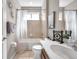 The full bathroom has a shower-tub combo, neutral tiling, and a white vanity at 8635 Creedmoor Ln, New Port Richey, FL 34654