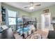 Inviting bedroom featuring a bunk bed, ample natural light, and charming decor, perfect for children at 8635 Creedmoor Ln, New Port Richey, FL 34654