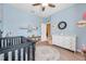 Charming Bedroom featuring a crib, a round rug, and decorative touches, perfect for a baby's room at 8635 Creedmoor Ln, New Port Richey, FL 34654