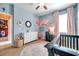 Charming Bedroom featuring a crib, a round rug, and decorative touches, perfect for a baby's room at 8635 Creedmoor Ln, New Port Richey, FL 34654