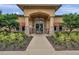 A beautiful entrance to the WatersEdge community clubhouse with stone accents and manicured landscape at 8635 Creedmoor Ln, New Port Richey, FL 34654