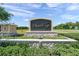 WatersEdge community sign with stone base and lush green plants and a glimpse of guard house at 8635 Creedmoor Ln, New Port Richey, FL 34654