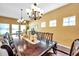 The formal dining area features an elegant wood table, seating for ten, and modern lighting at 8635 Creedmoor Ln, New Port Richey, FL 34654