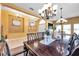 Open-concept dining area boasts stylish lighting fixtures and a large table perfect for gatherings at 8635 Creedmoor Ln, New Port Richey, FL 34654