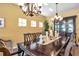 Formal dining room featuring wood table with seating for eight, unique fixtures and natural light at 8635 Creedmoor Ln, New Port Richey, FL 34654