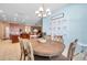 Cozy dining room features modern chandelier and blue accent wall at 8635 Creedmoor Ln, New Port Richey, FL 34654