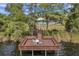 Waterfront dock with seating area overlooking the pool, clubhouse, and the lake in a beautiful setting at 8635 Creedmoor Ln, New Port Richey, FL 34654
