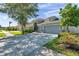 Charming single-Gathering home with well-manicured lawn, mature trees, and a three car garage at 8635 Creedmoor Ln, New Port Richey, FL 34654
