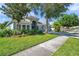 Landscaped front yard leading to a well-maintained single-story home with a two-car garage at 8635 Creedmoor Ln, New Port Richey, FL 34654