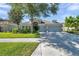 Single-story home featuring an arched entry, beautiful landscaping and a convenient two-car garage at 8635 Creedmoor Ln, New Port Richey, FL 34654