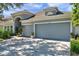 Charming home showcasing a two-car garage, an arched entry and manicured landscaping at 8635 Creedmoor Ln, New Port Richey, FL 34654