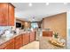Open-concept kitchen has granite countertops, tiled backsplash, stainless appliances, and ample cabinetry at 8635 Creedmoor Ln, New Port Richey, FL 34654