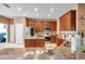 Open kitchen with stainless steel appliances and wooden cabinets and island at 8635 Creedmoor Ln, New Port Richey, FL 34654