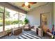 View of the screened lanai featuring comfortable seating and access to the outdoors at 8635 Creedmoor Ln, New Port Richey, FL 34654