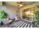 Cozy screened lanai with ceiling fan and outdoor seating, ideal for relaxation at 8635 Creedmoor Ln, New Port Richey, FL 34654