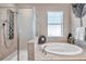 Modern main bathroom offering a separate shower stall and a luxurious soaking tub at 8635 Creedmoor Ln, New Port Richey, FL 34654