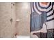 Shower featuring stylish tile, a shower head, and a decorative shower curtain at 8635 Creedmoor Ln, New Port Richey, FL 34654