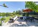 Beautiful outdoor patio with comfortable seating, dining set, and stunning lake view at 8945 Bella Vita Cir, Land O Lakes, FL 34637