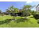 Sprawling backyard featuring lush lawn, mature trees, and a patio area perfect for entertaining at 8945 Bella Vita Cir, Land O Lakes, FL 34637