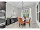 Cozy dining area features a round table, four upholstered chairs, and natural light from a window at 8945 Bella Vita Cir, Land O Lakes, FL 34637