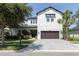 Beautiful two-story home with landscaped front yard, brick driveway, and a two-car garage at 8945 Bella Vita Cir, Land O Lakes, FL 34637