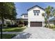 Beautiful two-story home with landscaped front yard, brick driveway, and a two-car garage at 8945 Bella Vita Cir, Land O Lakes, FL 34637