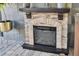 Stylish stone fireplace with hearth, adding warmth and charm to the interior at 8945 Bella Vita Cir, Land O Lakes, FL 34637