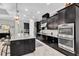 Modern kitchen boasts granite countertops, stainless appliances including double ovens and dark wood cabinets at 8945 Bella Vita Cir, Land O Lakes, FL 34637