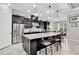 Spacious kitchen features stainless appliances, granite counters, pendant lighting and dark wood cabinets at 8945 Bella Vita Cir, Land O Lakes, FL 34637