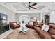Spacious living room with leather couches, decorative ceiling, and open access to the rest of the house at 8945 Bella Vita Cir, Land O Lakes, FL 34637