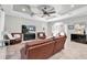 Cozy living room with leather furniture, a modern media center, and a view into the rest of the house at 8945 Bella Vita Cir, Land O Lakes, FL 34637
