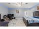 Bright bedroom featuring a ceiling fan, desk, and comfortable bed at 9078 Birmingham Ave, Weeki Wachee, FL 34613