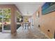Covered patio featuring tile flooring, outdoor seating, and a wall-mounted TV at 9078 Birmingham Ave, Weeki Wachee, FL 34613