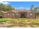 Charming single-story home featuring a stucco exterior, covered entry, and well-maintained landscaping at 9078 Birmingham Ave, Weeki Wachee, FL 34613