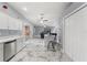 Open-concept kitchen with white cabinets, marble floors, and a view of the living room, creating a great flow at 9078 Birmingham Ave, Weeki Wachee, FL 34613