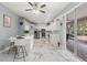 Bright kitchen with white cabinets, stainless steel appliances, marble floors, and a breakfast bar with seating at 9078 Birmingham Ave, Weeki Wachee, FL 34613