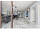 Bright living room with marble floors, modern lighting, neutral walls, and comfortable seating at 9078 Birmingham Ave, Weeki Wachee, FL 34613