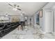Open-concept living room with marble floors, ceiling fans, comfortable seating, and access to the backyard at 9078 Birmingham Ave, Weeki Wachee, FL 34613