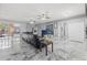 Spacious living room featuring sleek marble floors, a comfortable black leather sofa, and sliding glass doors to the outside at 9078 Birmingham Ave, Weeki Wachee, FL 34613