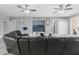 Spacious living room with marble floors, ceiling fans, recessed lighting, and a black leather sofa at 9078 Birmingham Ave, Weeki Wachee, FL 34613