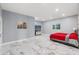 Bright main bedroom featuring a large bed, marble floors, and a large closet at 9078 Birmingham Ave, Weeki Wachee, FL 34613
